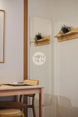 a glass wall with a table and some plants at Somnus Suites at Air Residences in Manila