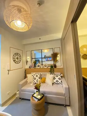 a living room with a couch and a window at Aesthetic walking distance to MOA,near NAIA AIRPORT with NETFLIX,MINIVIDEOKE,BOARDGAMES-DUXE2 in Manila
