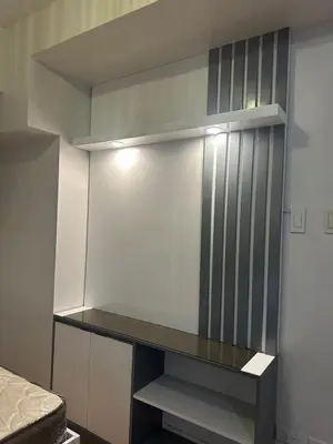 a room with a wall with a shelf and a bed at Newly Reneuvated Fully Furnished Condo Apartment in the Heart of Mandaluyong in Manila