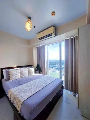 a bedroom with a large bed and a large window at Azure Urban Resort Parañaque Near Airport and SM Mall in Manila