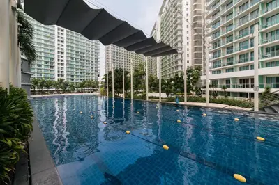 a swimming pool in the middle of two tall buildings at Azure Urban Residences by Lyn in Manila