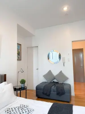 a bedroom with a bed and a mirror on the wall at Stars & Sunsets Sky Views 1br Iguazu Tower in Manila