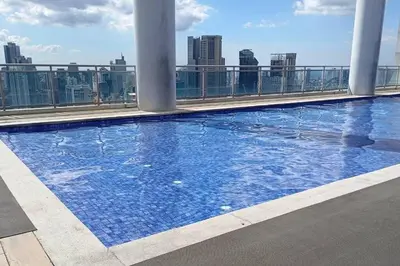 a large swimming pool on the roof of a building at Stars & Sunsets Sky Views 1br Iguazu Tower in Manila