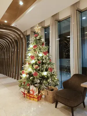 a christmas tree in a room with a chair at Sofia's place shore 3 tower 2 in Manila