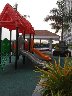 a playground at a resort with a slide at Condo With Water Views in Manila