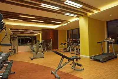 a gym with several exercise equipment in a room at US Embassy, Cozy Condo, Ermita, Manila Roxas Blvd in Manila