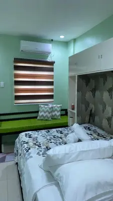 a bedroom with two white beds in a room at FACE Transient Rooms in Kawit