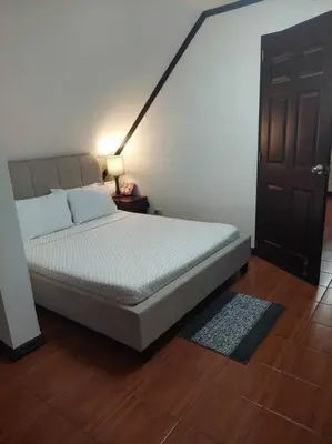 a bedroom with a bed and a door and a rug at Florie's Home in Santa Rosa