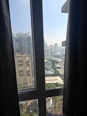 a view of a city from an office window at Affordable Stay near BGC, Makati in Manila