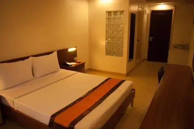 a bedroom with a large bed in a room at M Suites Hotel in Manila