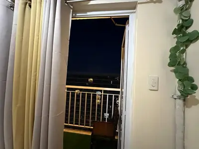 a window with a view of a balcony at SD2 tandem staycation in Manila
