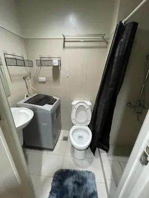 a bathroom with a toilet and a sink at SD2 tandem staycation in Manila
