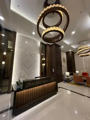 a lobby with a large chandelier and a reception desk at Modern Luxury 4BR Manila Bay beside Okada Manila in Manila