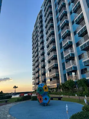 a large apartment building with a sculpture in front of it at Luxurious 3BR in Manila Bay beside Okada in Manila