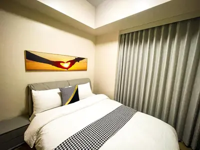 a bedroom with a bed and a painting on the wall at Luxurious 3BR in Manila Bay beside Okada in Manila