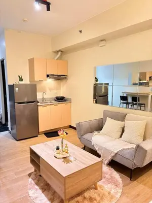 a living room with a couch and a table at Fair bears accommodation in Manila