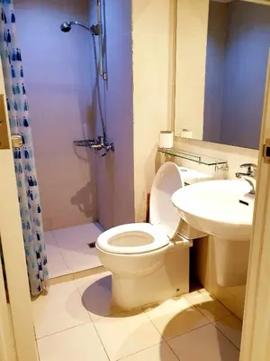 a bathroom with a toilet and a sink at 225 St Tropez Tower Azure Urban Resort Residences in Manila