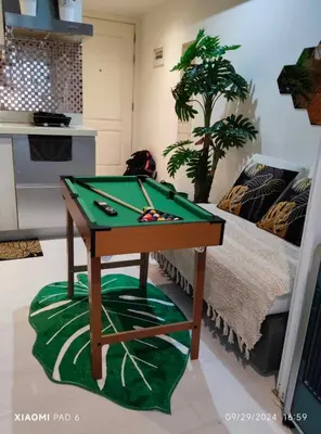 a pool table in a living room with a bed at 225 St Tropez Tower Azure Urban Resort Residences in Manila