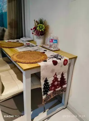 a table with a merry christmas sign on it at 225 St Tropez Tower Azure Urban Resort Residences in Manila