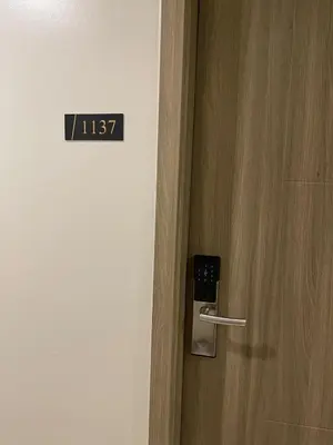 a close up of a door with a sign on it at Antoneitte Staycation in Manila