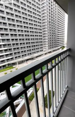 a balcony with a view of a large building at Antoneitte Staycation in Manila