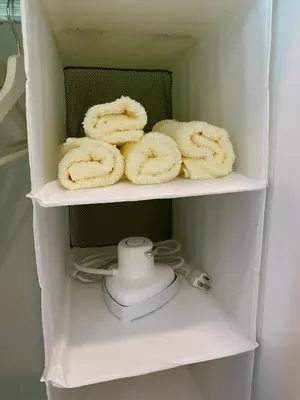 a shelf of a refrigerator with some white towels at La Casa Benice in Manila