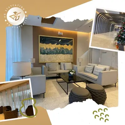 a living room with couches and chairs and a painting at 1br with Balcony near MOA unit 2 in Manila