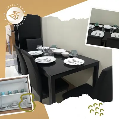 a black dining room table with chairs and plates on it at 1br with Balcony near MOA unit 2 in Manila
