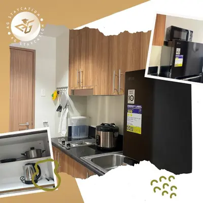 a kitchen with a sink and a stove top oven at 1br with Balcony near MOA unit 2 in Manila