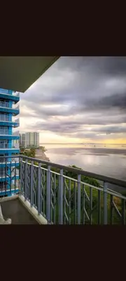 a view of the ocean from a balcony of a building at One Winstar Realty Corp in Manila