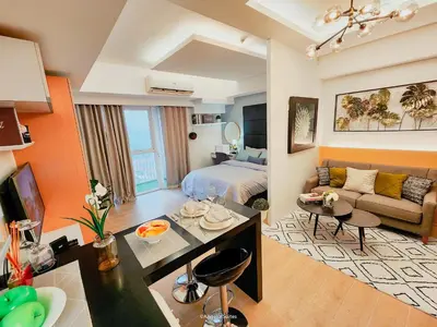 a large living room with a bed and a couch at One Bedroom Unit with Venice Canal View in Manila