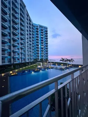 a view from a balcony of a building with a pool at Bayshore 2 Residential Resort Phase 1 in Manila
