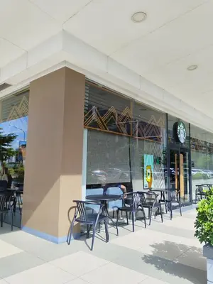 a group of tables and chairs outside of a building at Shore Residences Family Suite near MOA 1 Bedroom with Balcony - 3beds good for 6 person in Manila