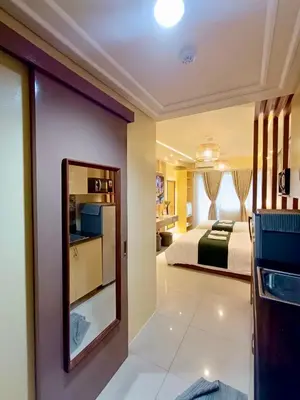 a hotel room with a bedroom and a bed at Crib2Go Lupita Suite with City Street View in Manila