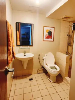 a bathroom with a toilet and a sink at Furnished 2Bedroom 2Bathroom plus Utility Room with 2 Beds in Manila