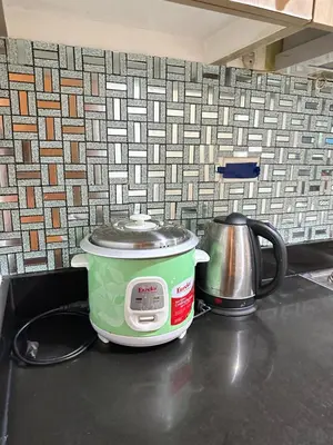a slow cooker on a counter next to a tea kettle at shore 880 staycation in Manila