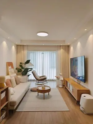 a living room with a white couch and a tv at Smith's Apartment in Taytay
