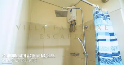 a shower in a bathroom with a sign on the wall at 1 Bed Room Shell Residence at Heart of Metro Manila - Pasay City in Manila