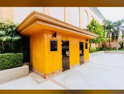 a small yellow building in front of a building at Venetian Haven BGC Venice Grand Canal Apart ment, 4 Bedrooms, for 10 Guests in Manila
