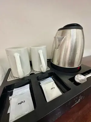 a table with a blender and two cups on it at Studio Two Condominium - Alabang, BLK - Northgate Cyberzone, Filinvest City, Alabang - Netflix-ready Fiber Wi-Fi in Manila