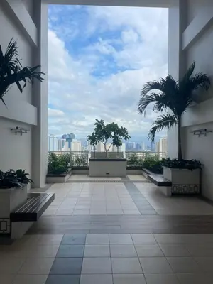 a large room with palm trees in a building at Vincondotel Near BGC Fairlane in Manila
