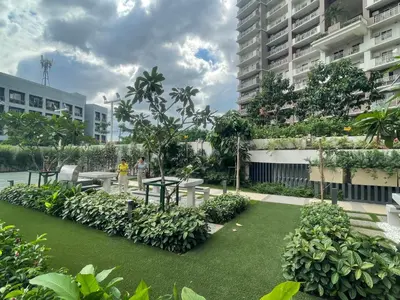 a courtyard in a building with grass and plants at Vincondotel Near BGC Fairlane in Manila