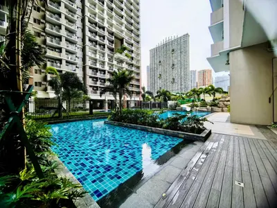 a large swimming pool in the middle of a city at Vincondotel Near BGC 2BR Fairlane in Manila