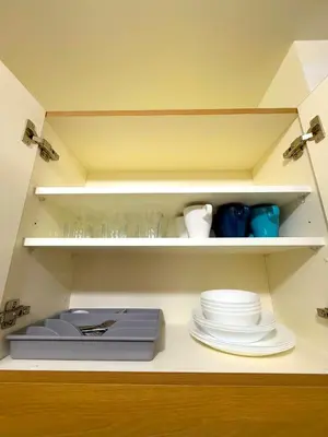 a shelf with plates and a scale in a kitchen at Vincondotel Near BGC 2BR Fairlane in Manila