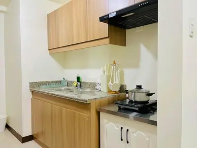 a kitchen with a sink and a counter top at Fairlane Residences in Manila