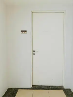 a white door with a sign on it at Fairlane Residences in Manila