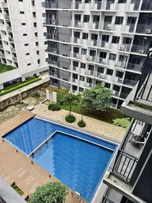 an empty swimming pool in the middle of a building at Stylish and Modern Suite with Pool Access and Parking in Manila