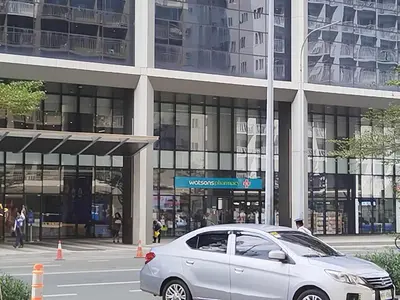 a silver car parked in front of a building at Pasay Shore Residences with one bedroom with balcony in Manila
