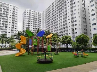 a playground in front of a large building at Pasay Shore Residences with one bedroom with balcony in Manila