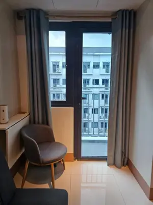 a room with a chair and a large window at Best Place For You - Mall of Asia & Airport in Manila